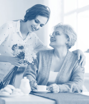 caregiver giving flowers to her senior patient