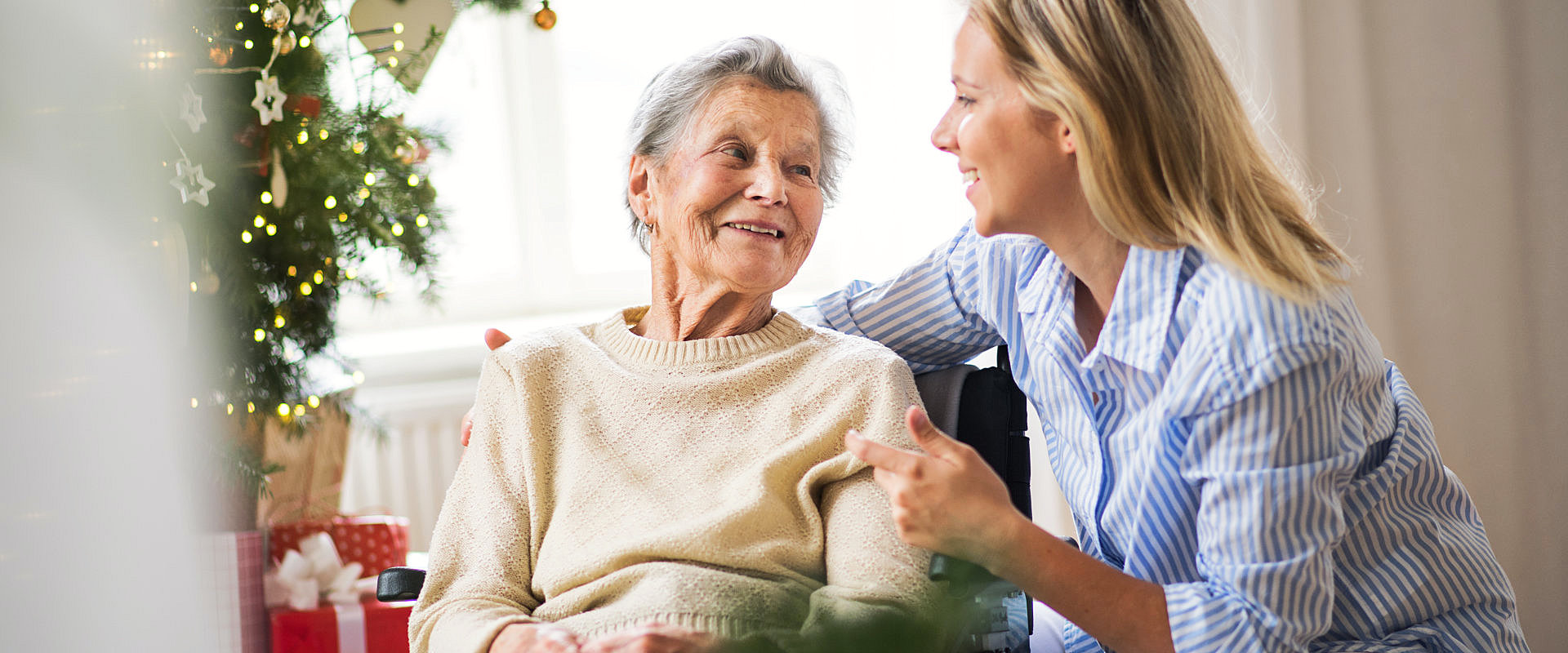 caregiver talking with her senior patient